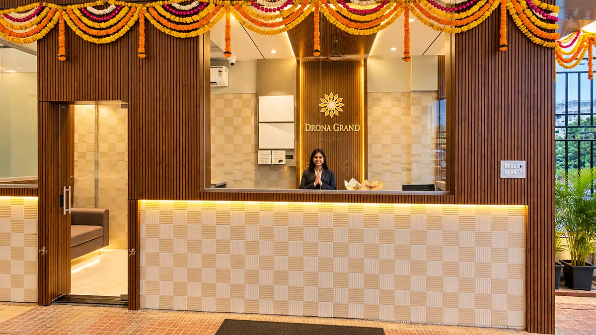 Reception desk at Hotel Drona Grand with a warm welcome from the front desk team